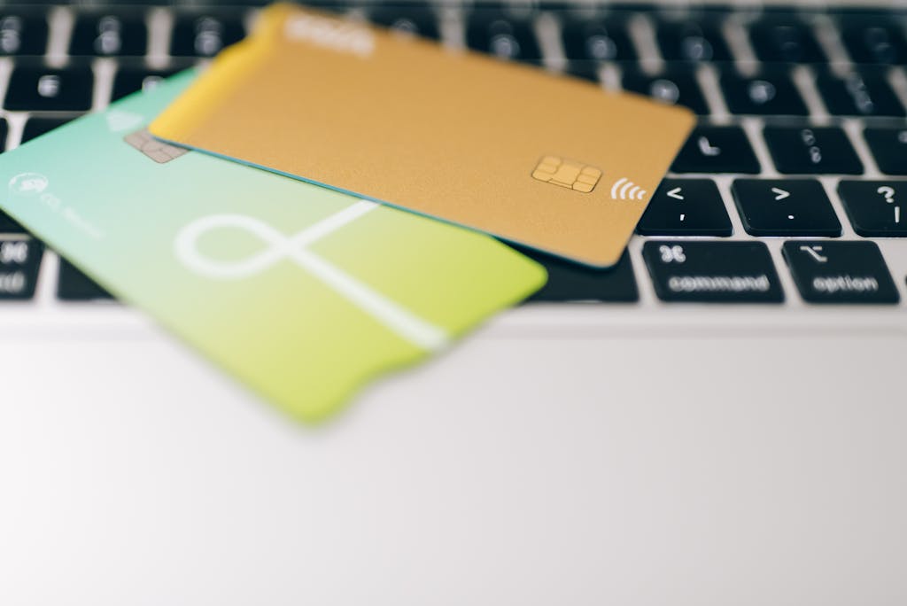 Two credit cards placed on a laptop keyboard highlighting online payment concept.